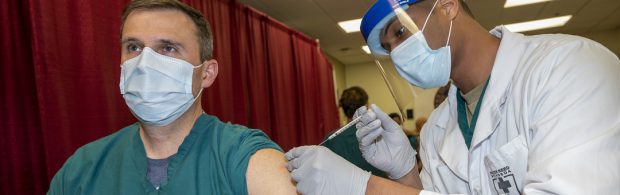 Verpleegkundige laat zich voor de camera 'vaccineren' met lege injectiespuit 1 verpleegkundige