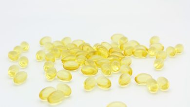 Omega-3 vis krill algen capsules naast verse vis op tafel